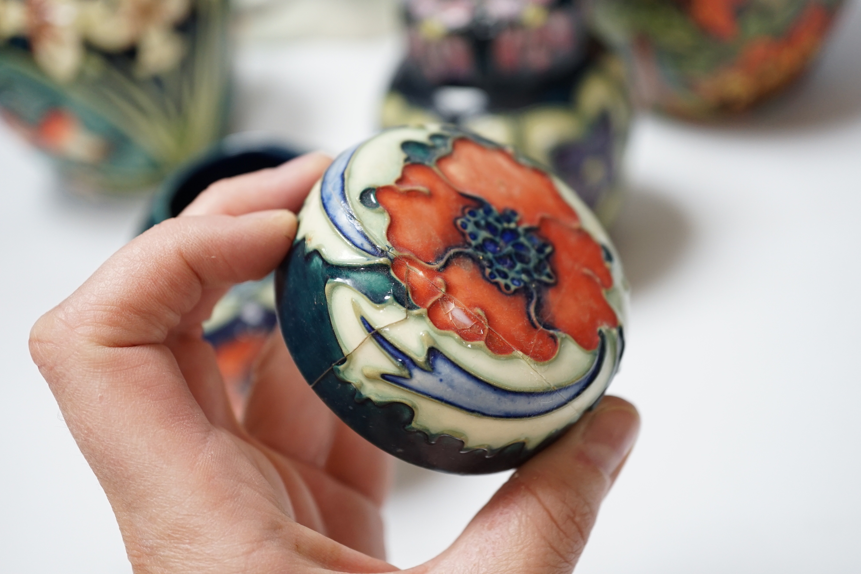 Four modern Moorcroft jars and covers, largest 16cm high, three boxed and a Nao figure group, tallest 95cm high